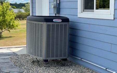 An Air Source Heat Pump next to a home.