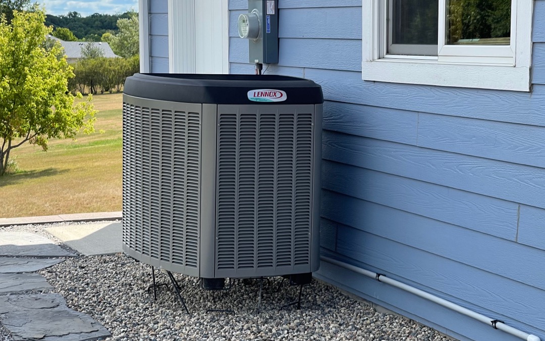 An Air Source Heat Pump next to a home.