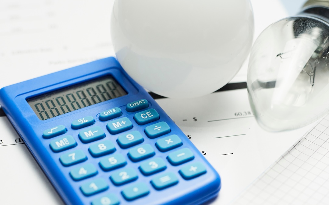 Calculator and light bulbs on paper on a table