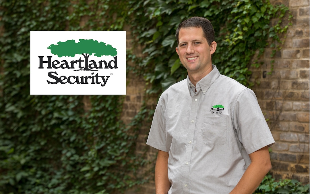 Heartland Security person standing in front of brick building